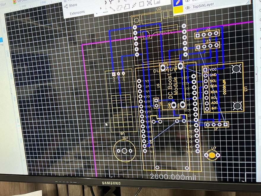 A monitor showing a printed circuit board layout in CAD software, with footprints for a DC boost module, an MPU6050 and connector headers.